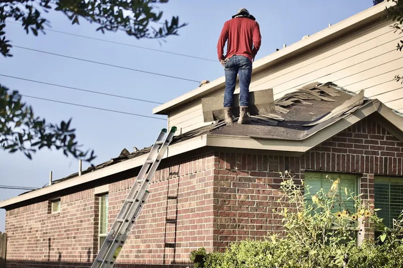 Professional roofer working on a residential roof in Doral
